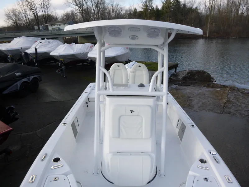 Slide: The Image of 2025 Sea Pro 230 Bay boat interior, featuring white seating and console design. - 9