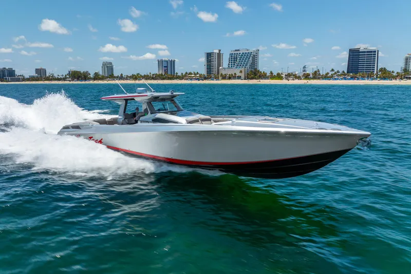 Slide: The Image of 2018 Nor-Tech 560 Sport Center Console cruising on ocean near city skyline. - 14