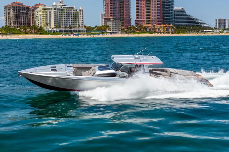 Slide: The Image of 2018 Nor-Tech 560 Sport Center Console cruising on ocean near city skyline. - 19
