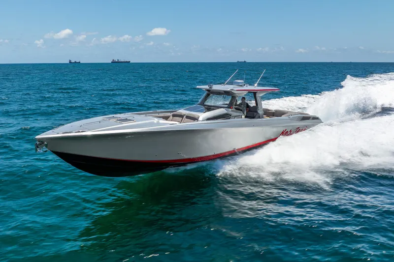 Slide: The Image of 2018 Nor-Tech 560 Sport Center Console cruising on open ocean waters. - 23