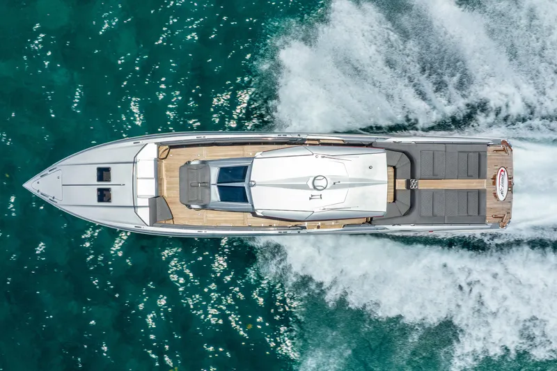 Slide: The Image of 2018 Nor-Tech 560 Sport Center Console cruising on clear turquoise water, aerial view. - 25
