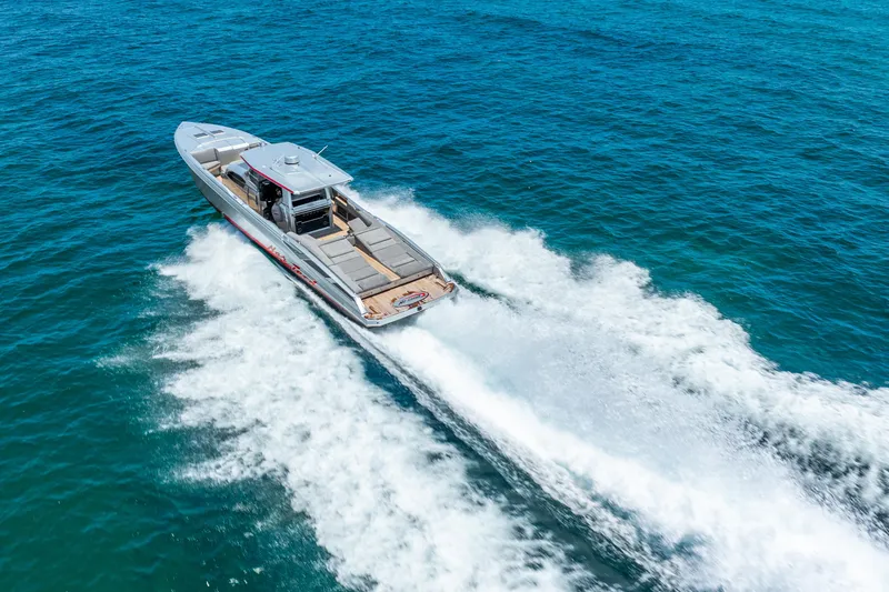 Slide: The Image of 2018 Nor-Tech 560 Sport Center Console cruising on open blue water. - 3