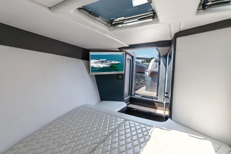 Slide: The Image of Interior of 2018 Nor-Tech 560 Sport Center Console with bed and TV. - 33