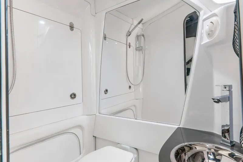 Slide: The Image of 2018 Nor-Tech 560 Sport Center Console bathroom with modern fixtures and sleek design. - 36