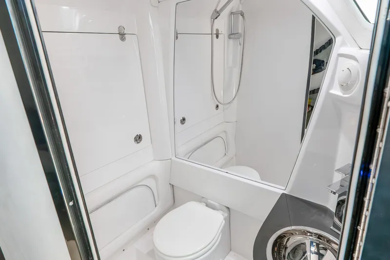 Slide: The Image of 2018 Nor-Tech 560 Sport Center Console bathroom with modern shower and toilet. - 37