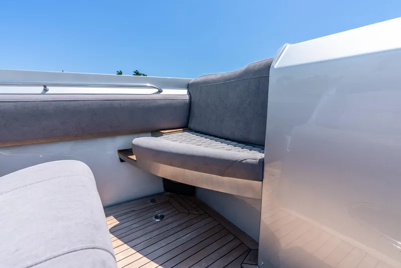 Slide: The Image of 2018 Nor-Tech 560 Sport Center Console interior with gray seating and wooden deck. - 41