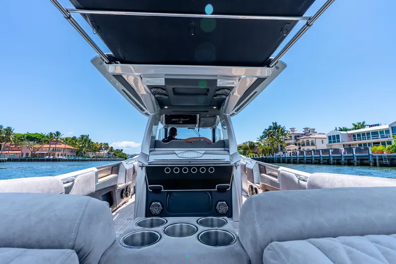 Slide: The Image of 2018 Nor-Tech 560 Sport Center Console boat interior with luxurious seating and cup holders. - 48