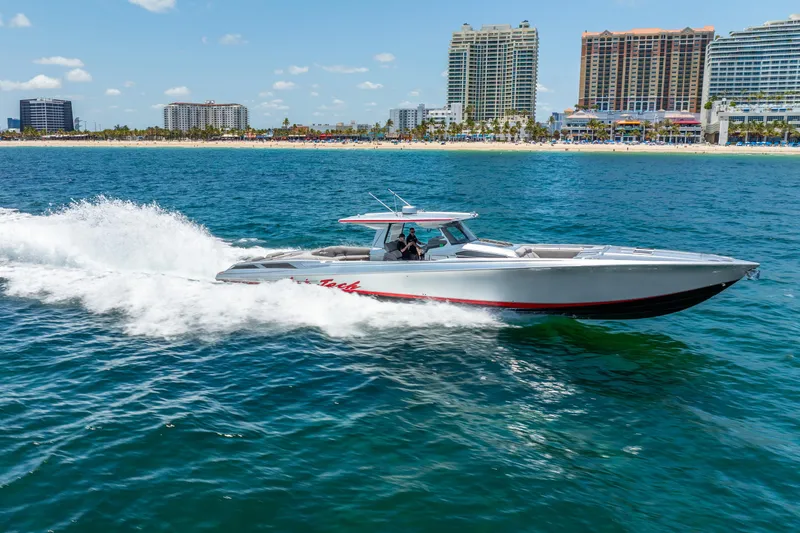 Slide: The Image of 2018 Nor-Tech 560 Sport Center Console cruising near a city shoreline. - 5