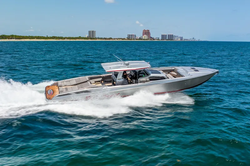 Slide: The Image of 2018 Nor-Tech 560 Sport Center Console cruising on open water, cityscape in background. - 9