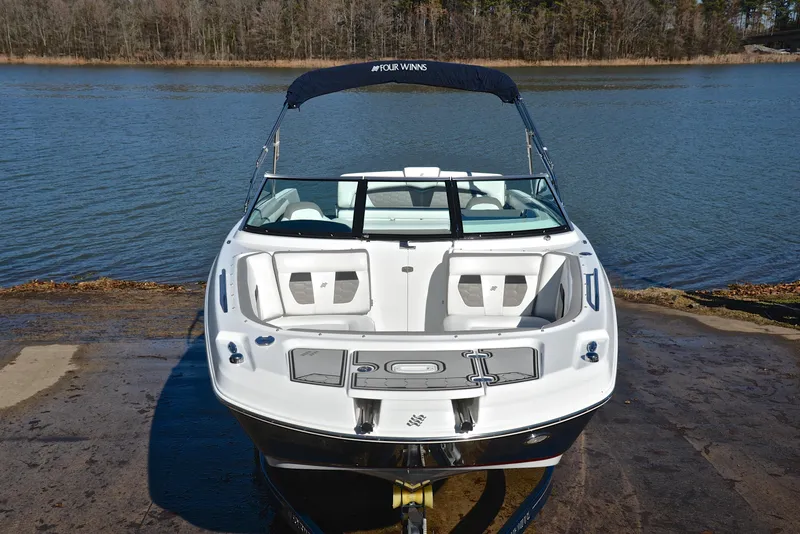 Slide: The Image of 2021 Four Winns HD3 boat on a ramp by a lake. - 17