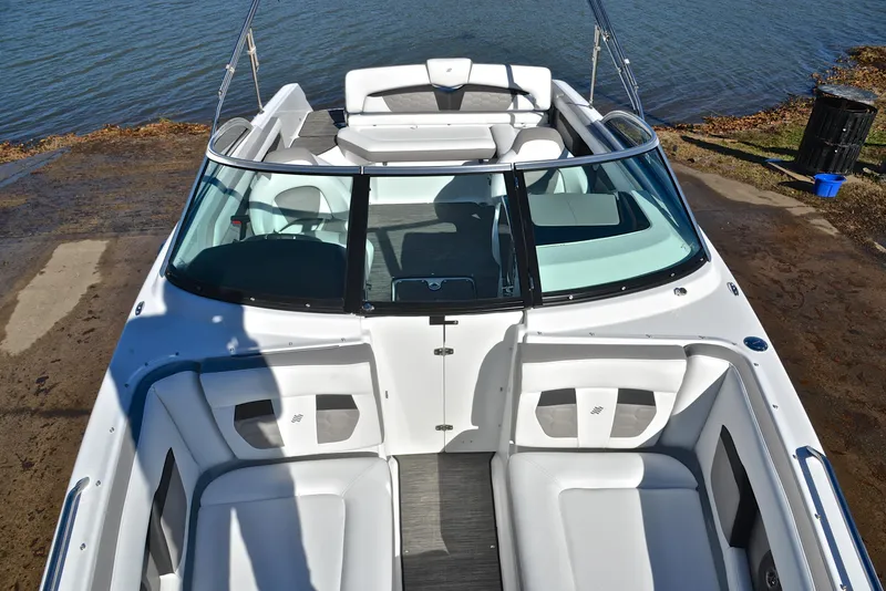 Slide: The Image of 2021 Four Winns HD3 boat with sleek design, docked by the water. - 20