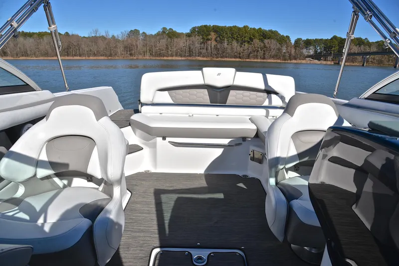 Slide: The Image of 2021 Four Winns HD3 boat interior with seating, on a calm lake. - 22