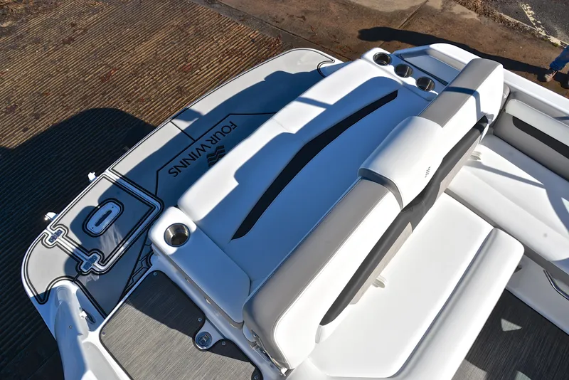 Slide: The Image of 2021 Four Winns HD3 boat interior with white seating and cup holders. - 23