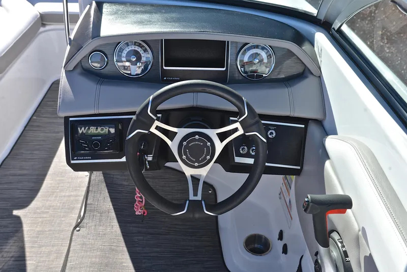 Slide: The Image of 2021 Four Winns HD3 boat dashboard with steering wheel and gauges. - 26