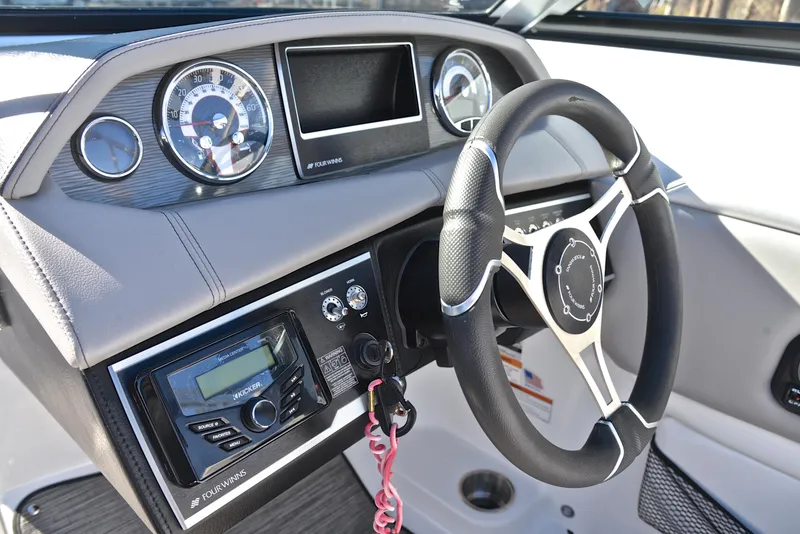 Slide: The Image of 2021 Four Winns HD3 boat dashboard with steering wheel and control panel. - 27