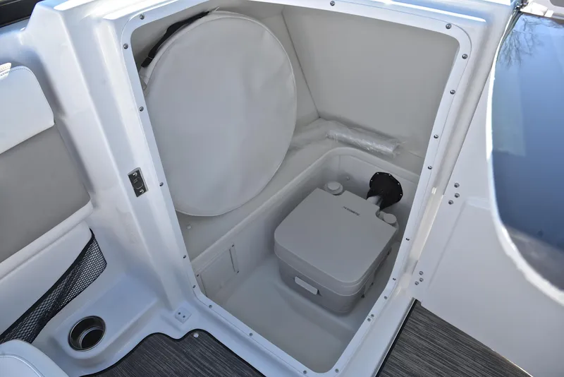 Slide: The Image of 2021 Four Winns HD3 boat interior storage compartment with portable toilet. - 28