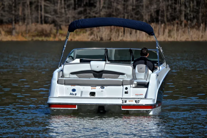 Slide: The Image of 2021 Four Winns HD3 boat on a calm lake, rear view. - 8