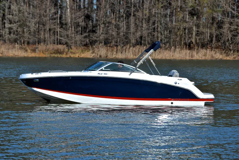 Slide: The Image of 2021 Four Winns HD3 boat on a calm lake with forest background. - 9