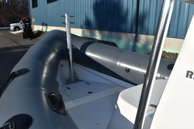 Slide: The Image of 2019 Ribcraft 6.5 inflatable boat docked near a blue building. - 3