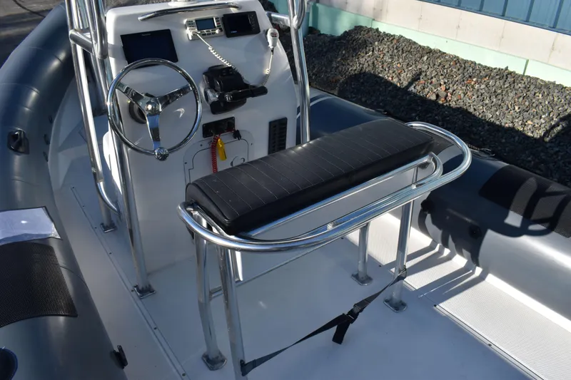 Slide: The Image of 2019 Ribcraft 6.5 boat console with steering wheel and seating. - 5