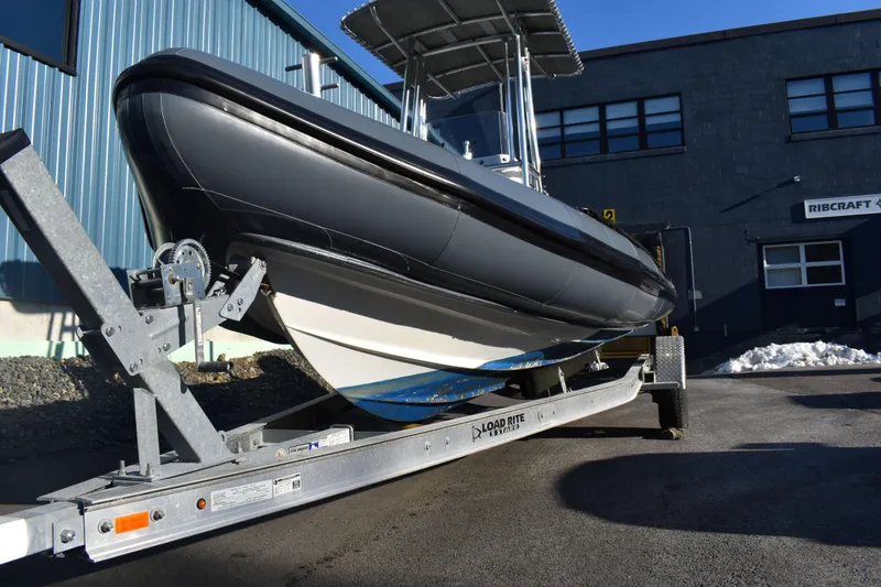 Slide: The Image of 2019 Ribcraft 6.5 boat on trailer, parked outside industrial building. - 7