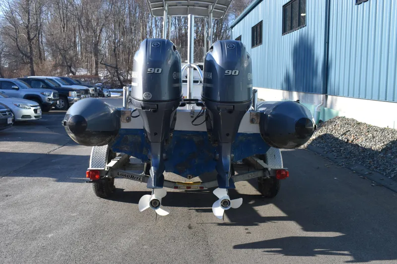 Slide: The Image of 2019 Ribcraft 6.5 boat with dual 90 horsepower engines on a trailer. - 9