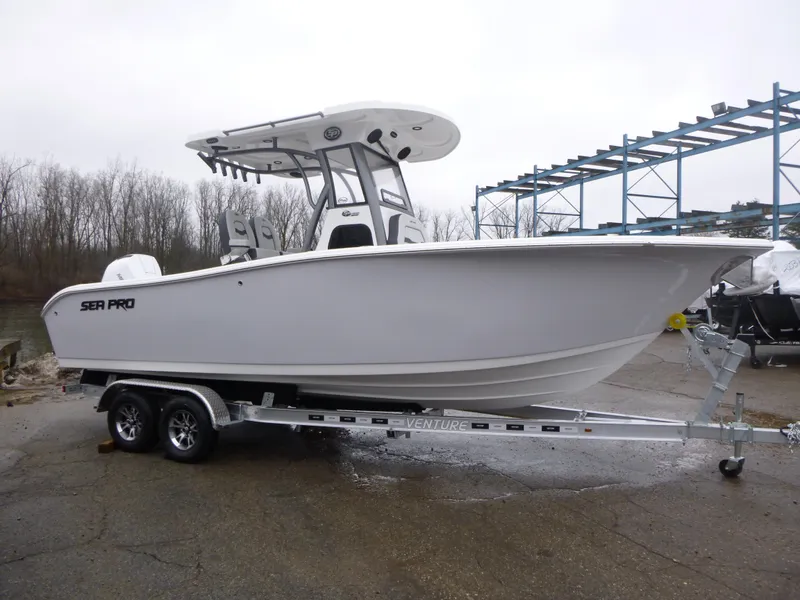 The Image of 2025 Sea Pro 242 Center Console boat on trailer, parked outdoors. - 0
