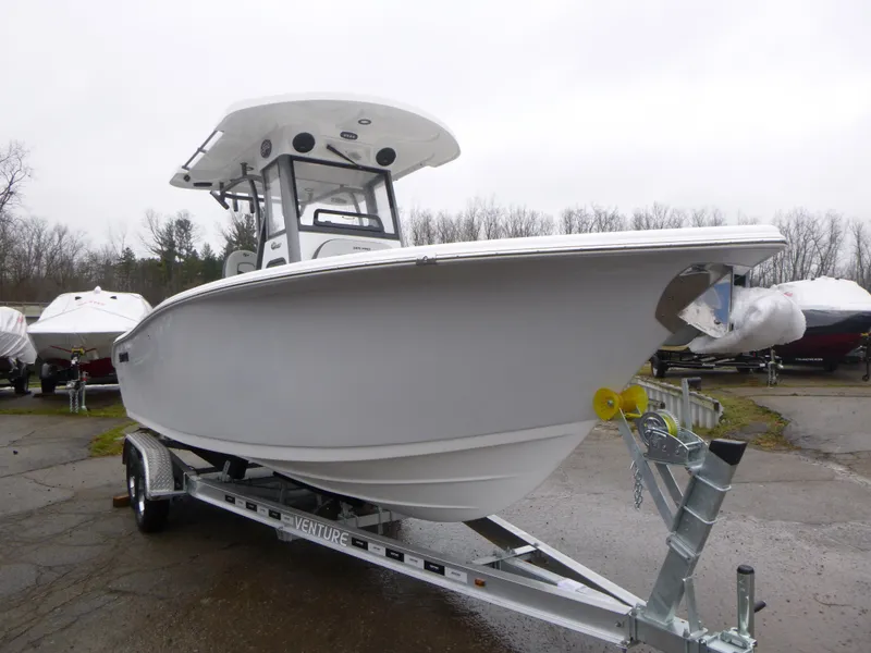Slide: The Image of 2025 Sea Pro 242 Center Console boat on trailer, parked outdoors. - 1