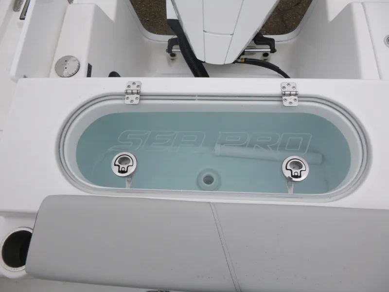 Slide: The Image of 2025 Sea Pro 242 Center Console livewell with clear lid and dual latches. - 14