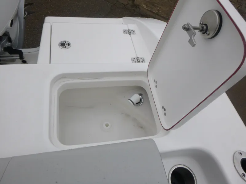 Slide: The Image of 2025 Sea Pro 242 Center Console boat storage compartment with open lid. - 15
