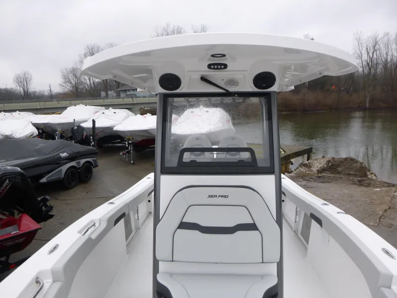 Slide: The Image of 2025 Sea Pro 242 Center Console boat docked near a lake on a cloudy day. - 19