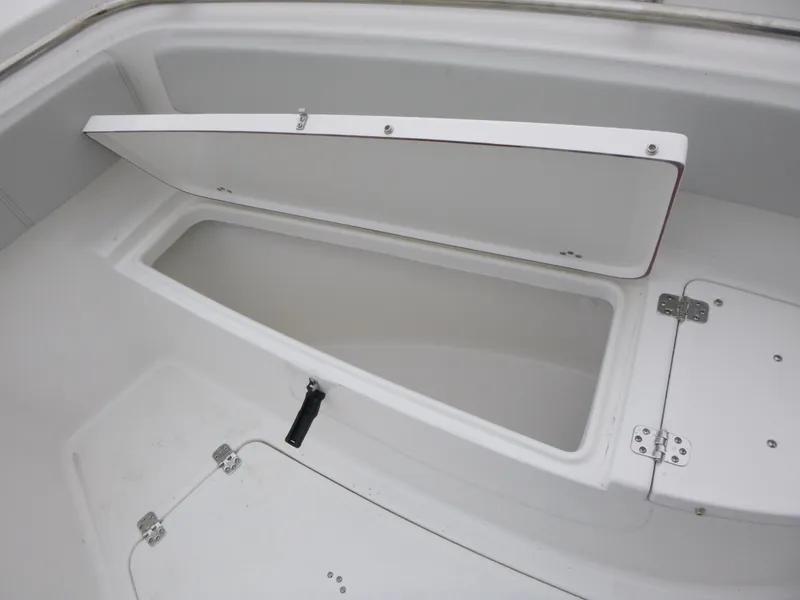 Slide: The Image of 2025 Sea Pro 242 Center Console boat storage compartment open. - 23