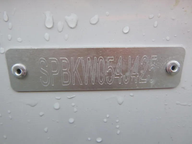 Slide: The Image of VIN plate on 2025 Sea Pro 242 Center Console boat, wet surface. - 25