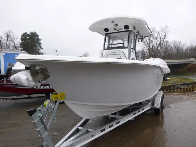 Slide: The Image of 2025 Sea Pro 242 Center Console boat on trailer, parked outdoors. - 3