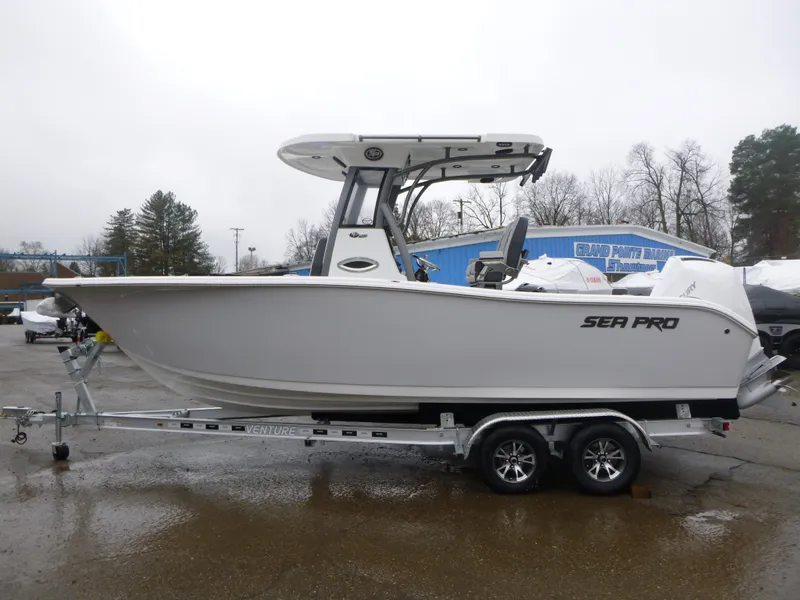 Slide: The Image of 2025 Sea Pro 242 Center Console boat on trailer, parked outdoors. - 4
