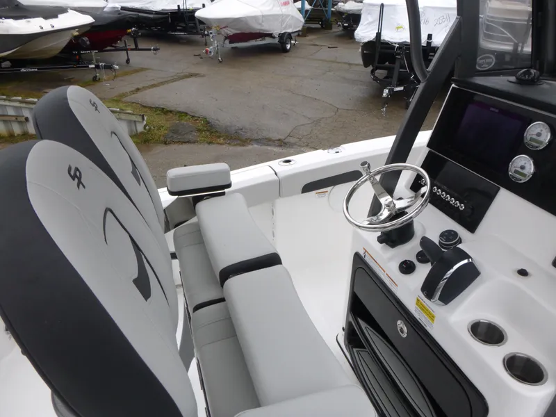Slide: The Image of 2025 Sea Pro 242 Center Console boat interior with steering wheel and seating. - 9
