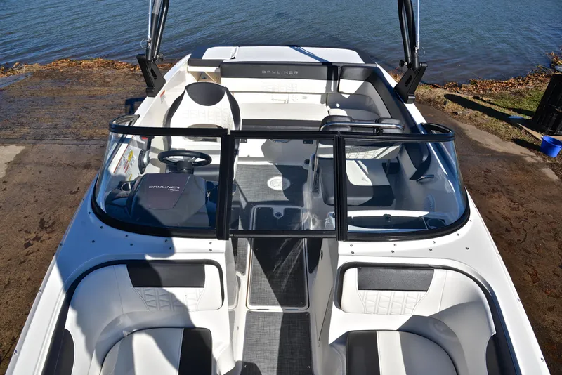 Slide: The Image of 2020 Bayliner VR5 boat interior with seating and steering wheel, docked by the water. - 16