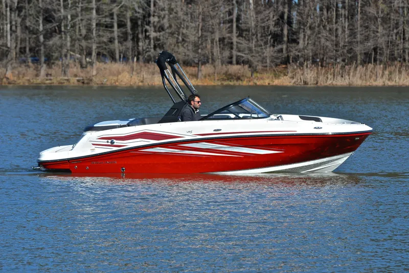 Slide: The Image of 2020 Bayliner VR5 boat cruising on a lake with a forested background. - 3