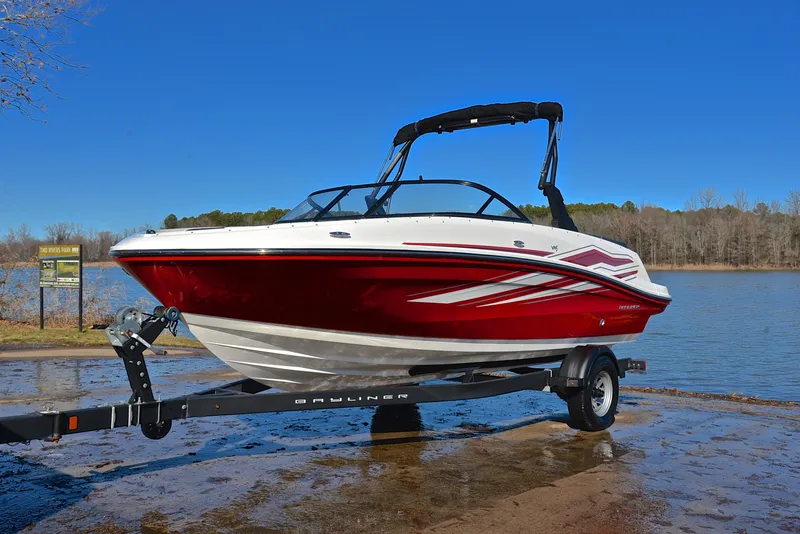 Slide: The Image of 2020 Bayliner VR5 boat on trailer by a lake, featuring a sleek red and white design. - 6