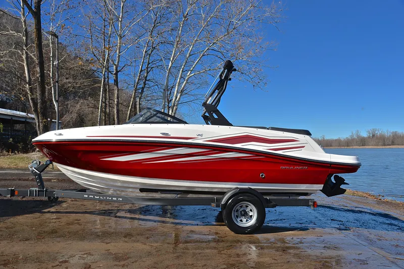 Slide: The Image of 2020 Bayliner VR5 boat with red and white design on a trailer by a lake. - 7