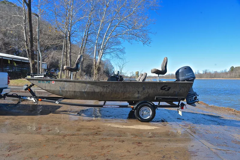 Slide: The Image of 2016 G3 Eagle 176 boat on trailer by a lake, clear blue sky. - 11