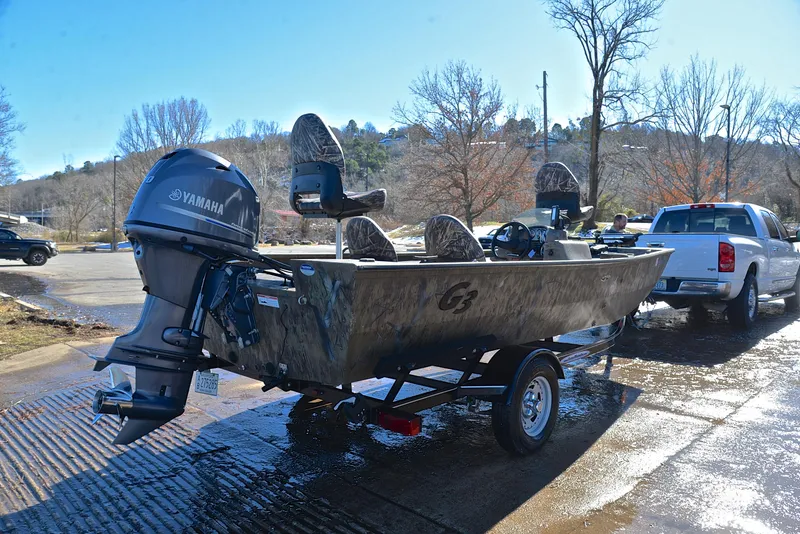 Slide: The Image of 2016 G3 Eagle 176 boat with Yamaha motor on trailer, parked near a truck. - 14