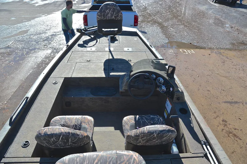 Slide: The Image of 2016 G3 Eagle 176 boat interior with camo seats and steering console. - 20