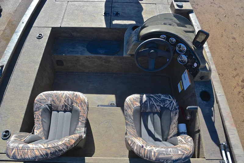 Slide: The Image of 2016 G3 Eagle 176 boat interior with camo seats and steering console. - 23