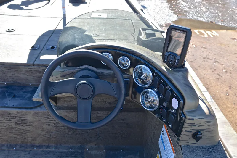 Slide: The Image of 2016 G3 Eagle 176 boat dashboard with steering wheel and gauges. - 24