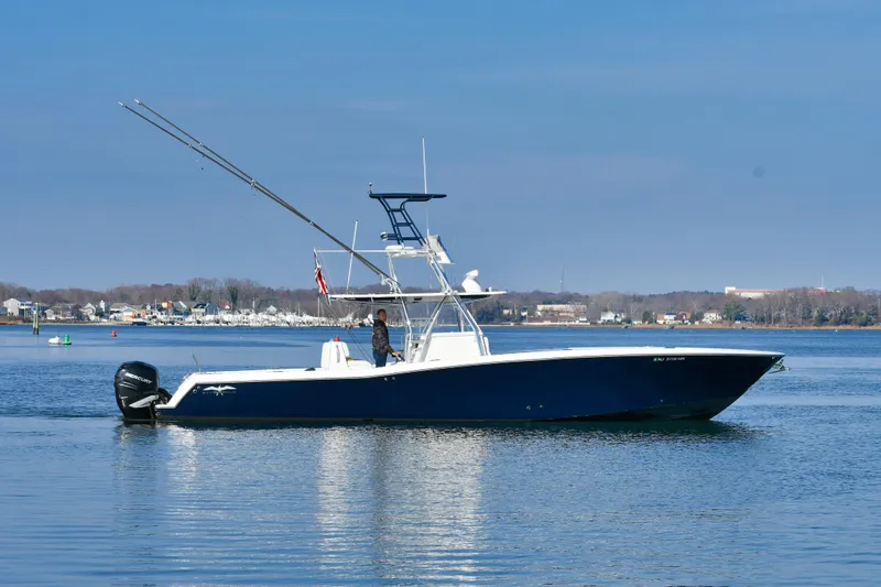 Slide: The Image of 2013 Invincible 42 Open Fisherman boat on calm water, side view. - 40