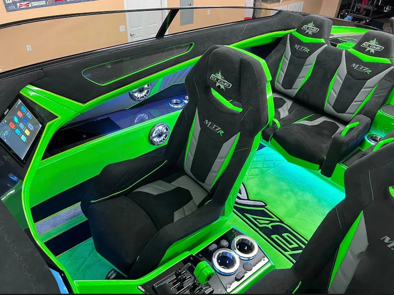 Slide: The Image of 2023 Daves Custom Boats M37R interior with vibrant green and black seating. - 11