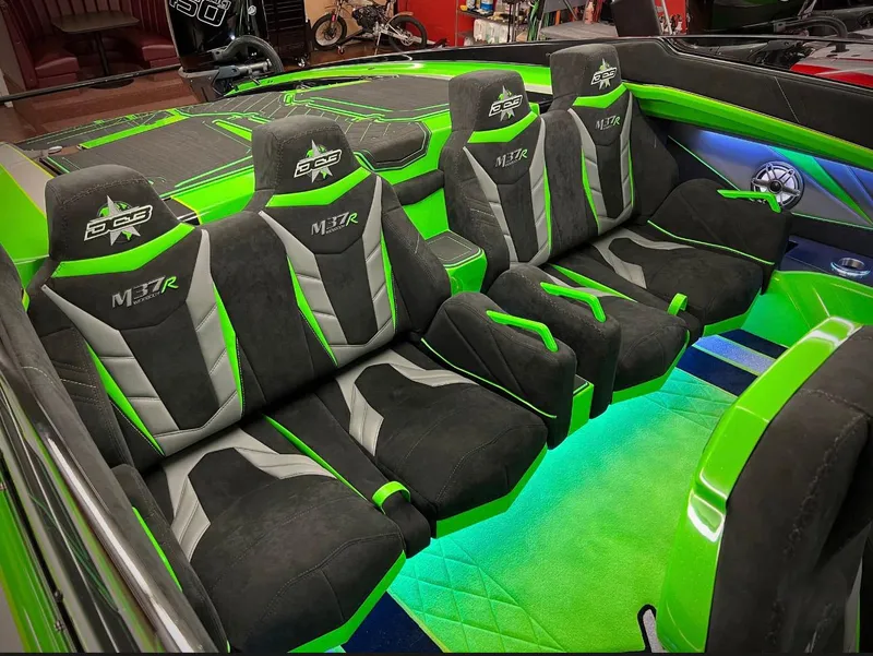 Slide: The Image of 2023 Daves Custom Boats M37R interior with green and black seats, illuminated accents. - 12