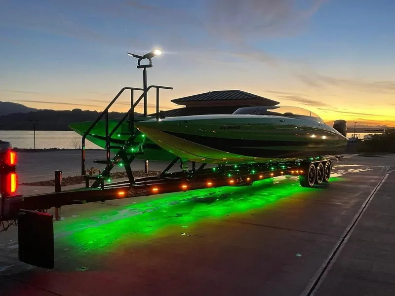 Slide: The Image of 2023 Daves Custom Boats M37R on trailer with green underglow at sunset. - 5