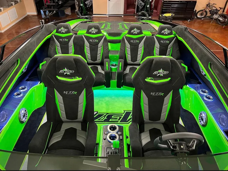 Slide: The Image of 2023 Daves Custom Boats M37R interior with vibrant green and black seating. - 7
